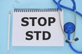 Stop STD ,Sexually transmitted diseases text written in Notebook with medical equipment on background