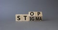 Stop and Stigma symbol. Businessman hand points at wooden cubes with words Stop and Stigma. Beautiful grey background. Business Royalty Free Stock Photo