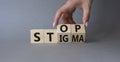 Stop and Stigma symbol. Concept words Stop and Stigma on wooden cubes. Beautiful grey background. Businessman hand. Business and Royalty Free Stock Photo