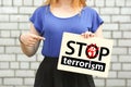 Stop terrorism concept. girl on a brick