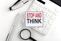 STOP AND THINK text on the sticker with calculator, glasses and magnifier Royalty Free Stock Photo