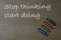 Stop thinking start doing.Motivational quote over wooden background Royalty Free Stock Photo
