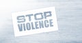 Stop violence words on card on wooden table. Social concept