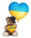 Stop war in Ukraine and humanitarian aid to refugees. Teddy bear showing a heart in the colors of the Ukrainian flag with the