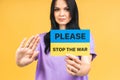 Stop war in Ukraine! Portrait of sad agressive angry woman holding in hands Ukrainian flag Royalty Free Stock Photo