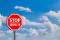 Stop warning sign coronavirus covid 19 in blue sky background Royalty Free Stock Photo