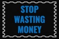 Stop Wasting Money text on dark screen Royalty Free Stock Photo