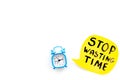 Stop wasting time hand letterng near alarm clock on white background top view copy space. Business concept, motivation Royalty Free Stock Photo