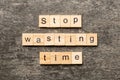 Stop wasting time word written on wood block. Stop wasting time text on cement table for your desing, Top view concept Royalty Free Stock Photo