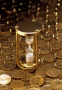 Stop watch on heaped of gold coins Royalty Free Stock Photo