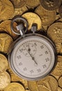 Stop watch on heaped of gold coins Royalty Free Stock Photo