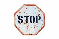 Stop written in bold letters in a rusty and grungy white and red old road traffic sign