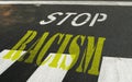 STOP written with paint on asphalt before an intersection in perspective from above Royalty Free Stock Photo