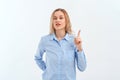 Stop. Young serious woman shaking finger scolding gesture, warning, prohibit smth, saying no, stands in blue shirt. Indoor studio