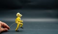 Stopmotion process of walking. Fourth step. Man\'s hand holding with an aluminum wire a figure made with yellow modeling Royalty Free Stock Photo