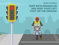 When stopped, keep both brakes on and keep left foot on the ground. Front view of a biker waiting on red traffic signal.