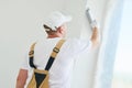 Painter with putty knife. Plasterer smoothing esconson surface at home renewal Royalty Free Stock Photo