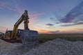 A stopping yellow excavator