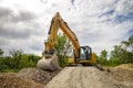 Yellow excavator for rest, at a construction site