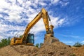 A stopping excavator for rest, at fluffy clouds