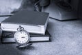 Stopwatch and book on wooden