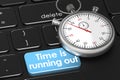 Stopwatch and keyboard with time is running out word Royalty Free Stock Photo