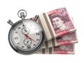 Stopwatch with packs of UK pounds isolated on white. Fast credit, financial and investments, time is money concept