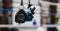 A stopwatch and a whistle hanging by their lanyards in a gym.