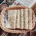 A storage basket made of natural wood filled with tortilla rolls Royalty Free Stock Photo