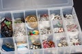 Storage box of buttons used to create jewelry