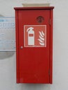 Storage box for a fire extinguisher at a garage facility. Royalty Free Stock Photo