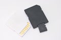 Storage card and adapter on white background for data transfer and memory expansion in electronic devices Royalty Free Stock Photo