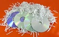 Storage discs and shredded paper sheets Royalty Free Stock Photo