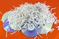 Storage discs and shredded paper sheets Royalty Free Stock Photo