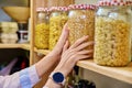 Storage of food in the kitchen in pantry, woman's hands with can of dry peas Royalty Free Stock Photo