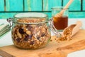 Storage jar with granola grain shovel and honey dipper Royalty Free Stock Photo