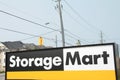 storage mart sign with power lines cables traffic light and road behind. p Royalty Free Stock Photo