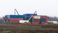 Storage of old containers. Old container yard at shipping port dock awaiting transportation Royalty Free Stock Photo