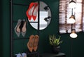 Storage rack with stylish women`s shoes in hallway Royalty Free Stock Photo