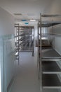 In the storage room for sterile instruments stands a new empty metal shelf