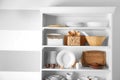 Storage stand with tableware and kitchen utensils Royalty Free Stock Photo