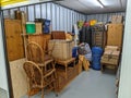 Self storage unit clearance packing furniture into room Royalty Free Stock Photo