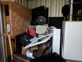 A self storage unit full of stored household junk items