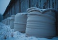 Storage warehouse filled with grain sacks lined up in the snow Royalty Free Stock Photo