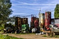 Storage yard and scrap collecting area for old agricultural equipment, silos, tractors and other scrap around barn and warehouse Royalty Free Stock Photo