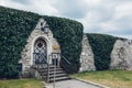 Store cafe with iron door and stone wall in garden of Wawel Castle in Krakow, Poland. Ancient architecture