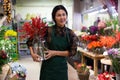 Store employee makes Christmas arrangement with flowers