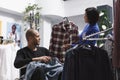 Store employee showcasing customer shirt