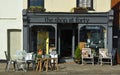 Store front of The Shop at Forty which sells Retro and Vintage wares with chairs and tables outside on the pavement.