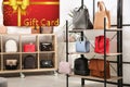 Store gift card. Collection of stylish woman`s bags in modern shop